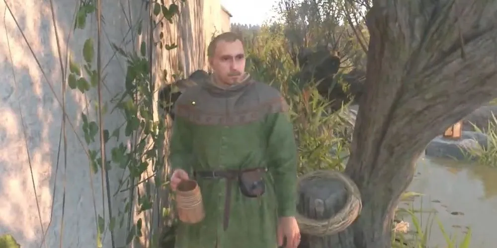 Vostatek đang uống rượu bên ao trong Kingdom Come: Deliverance 2