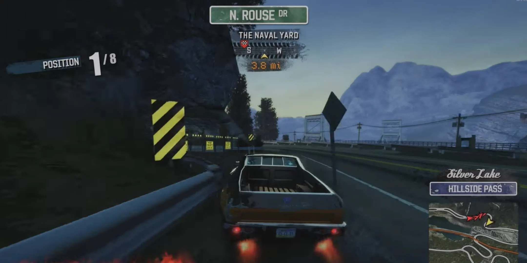 Một chiếc xe bán tải màu đỏ đang drift và bốc khói trên đường trong Burnout Paradise Remastered