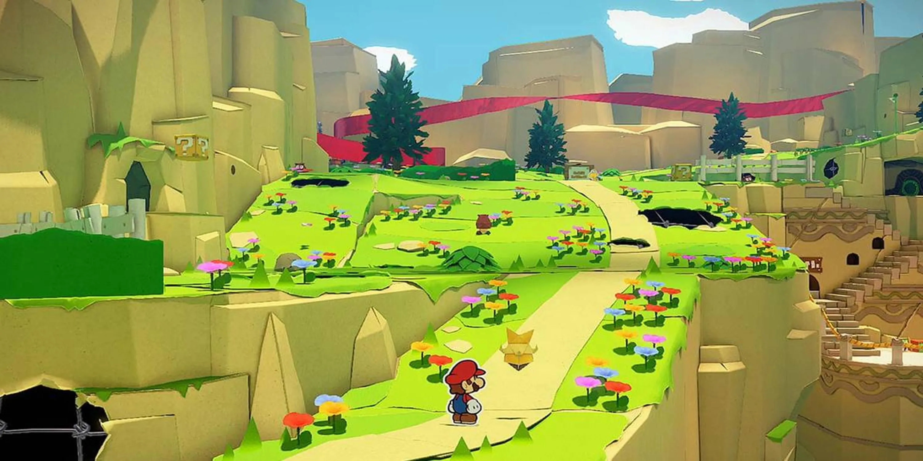 Mario đứng trên con đường dẫn lên đồi trong Paper Mario: The Origami King, thể hiện đồ họa độc đáo của game.
